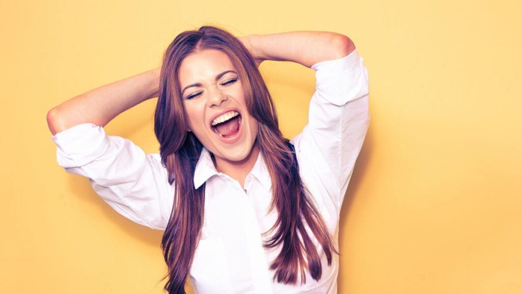 A happy woman with her arms behind her head