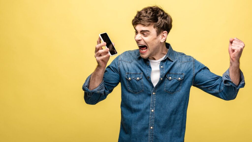 Angry man yelling at his phone