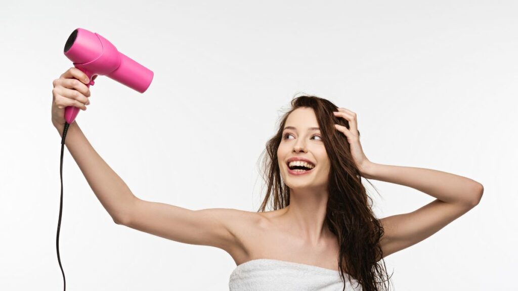 Blowdrying areas woman wearing a towel blowdrying her hair