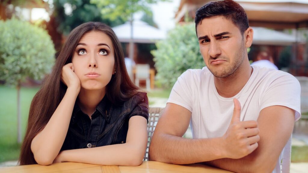 bored woman on bad date with confident man next to her