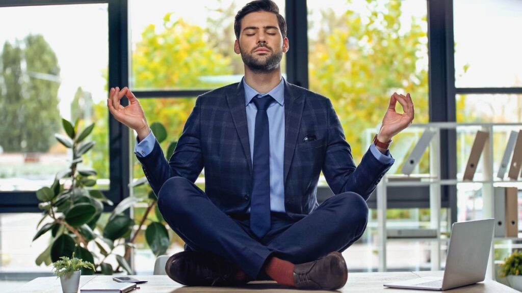 Calm Him: man in a suit meditating