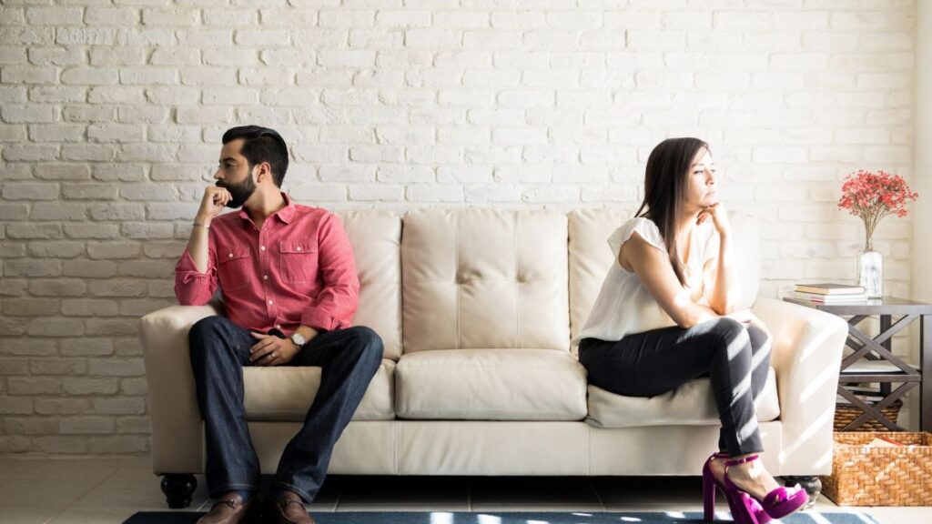 Cool Off Period: couple sitting and looking away from each other on a couch