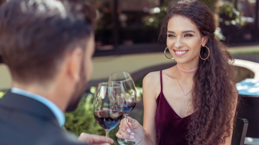 couple clinking wine glasses on a date