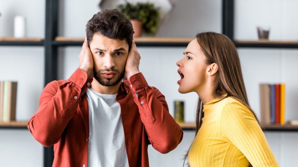 Couple fighting - man is holding his ears and woman is yelling