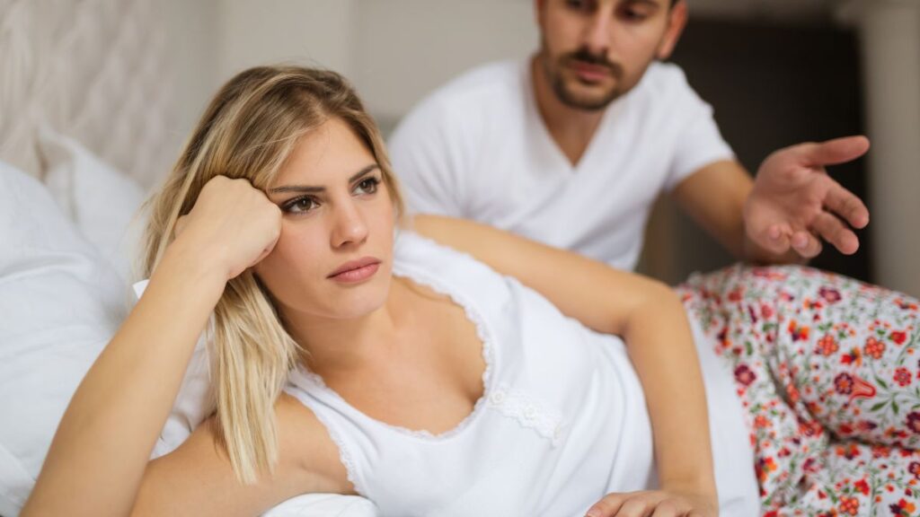 couple fighting woman laying down looking away from man