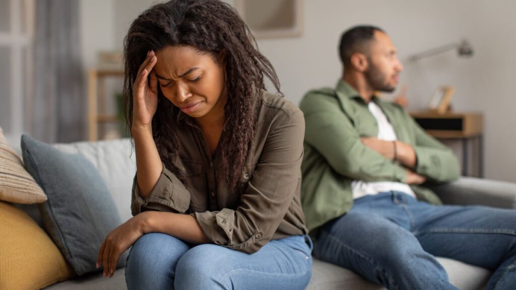 couple fighting woman upset sitting away from upset man