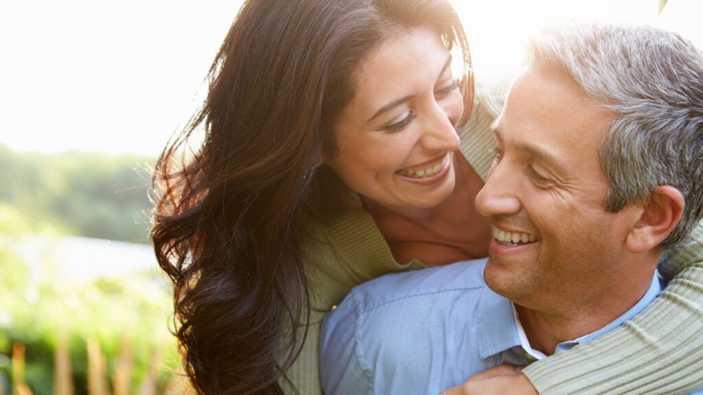 couple hugging in a field