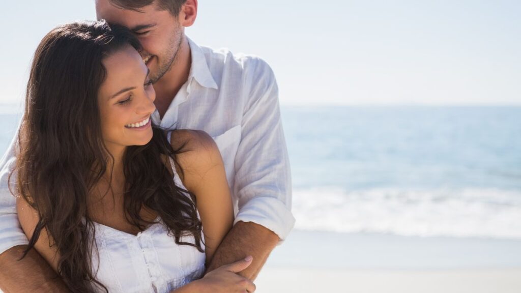 couple hugging on the beach