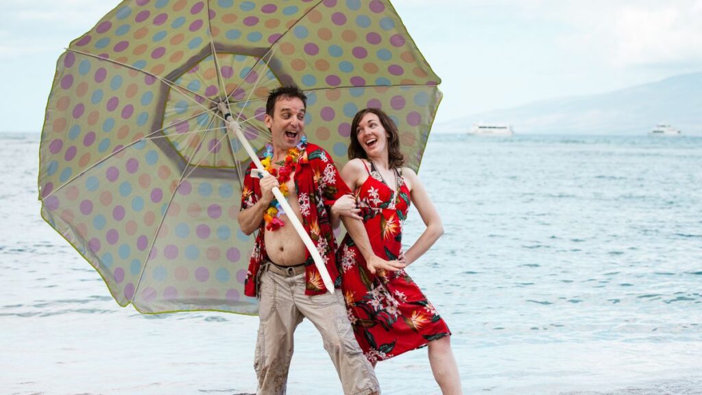 couple in matching outfits posing on the beach