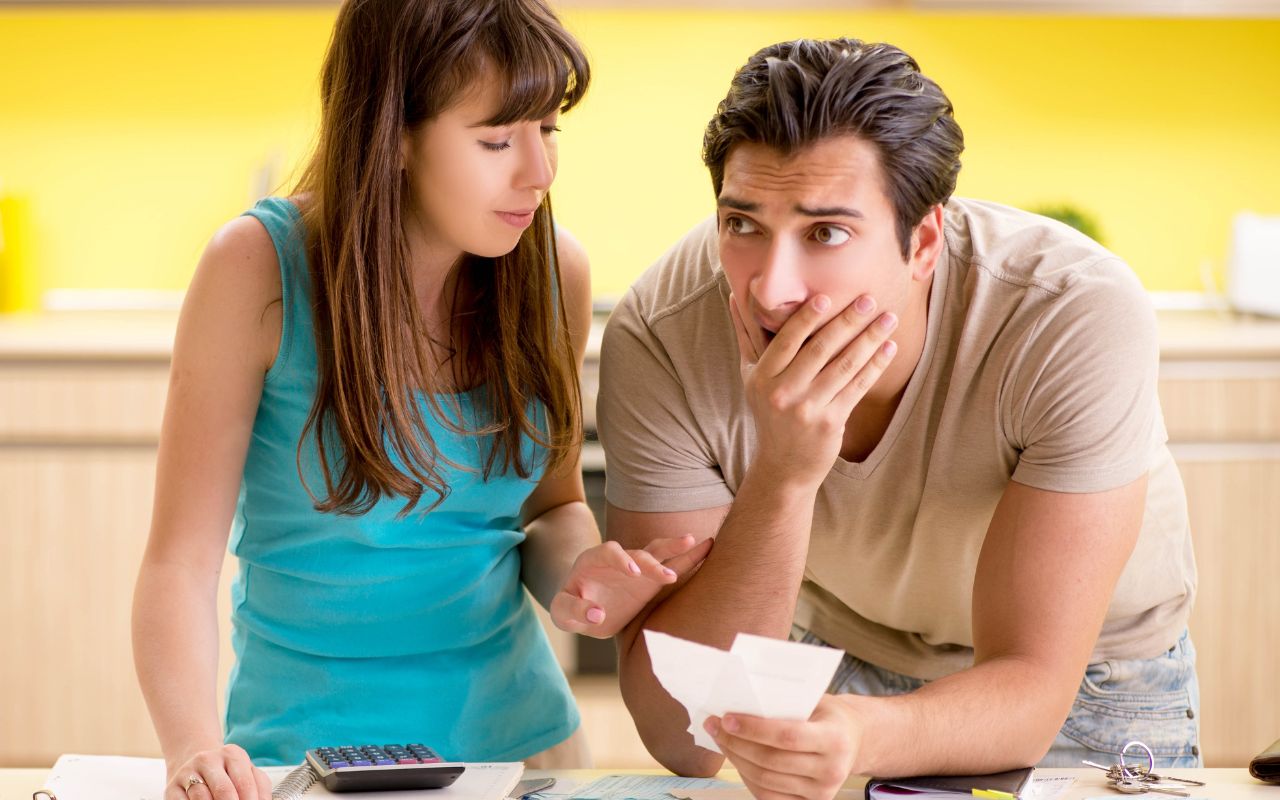 Couple looking over bills worried about money