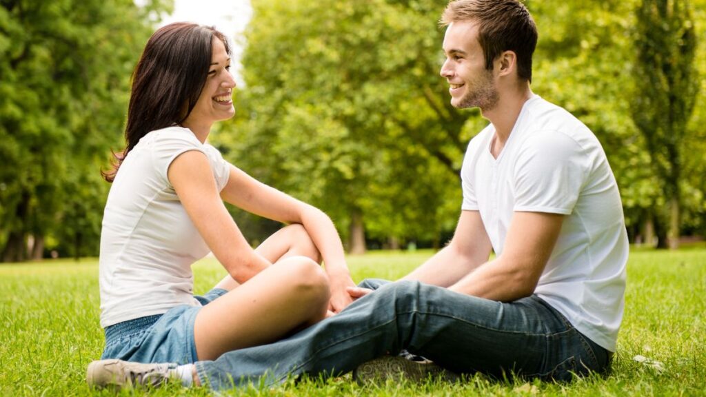 couple sitting on the grass talking