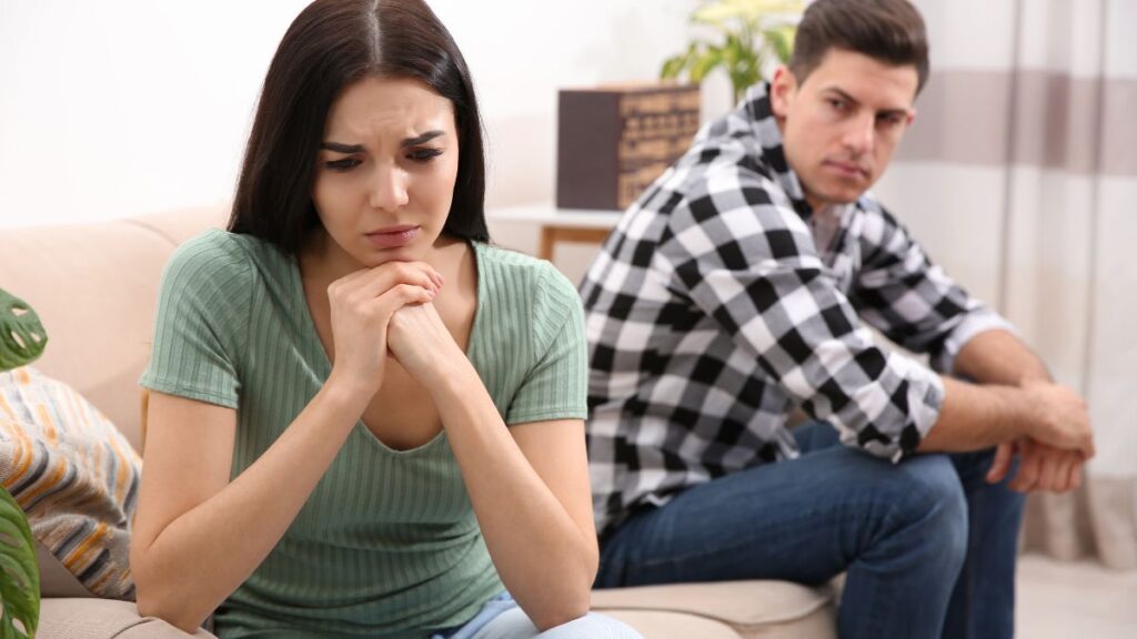 couple sitting upset looking away from each other