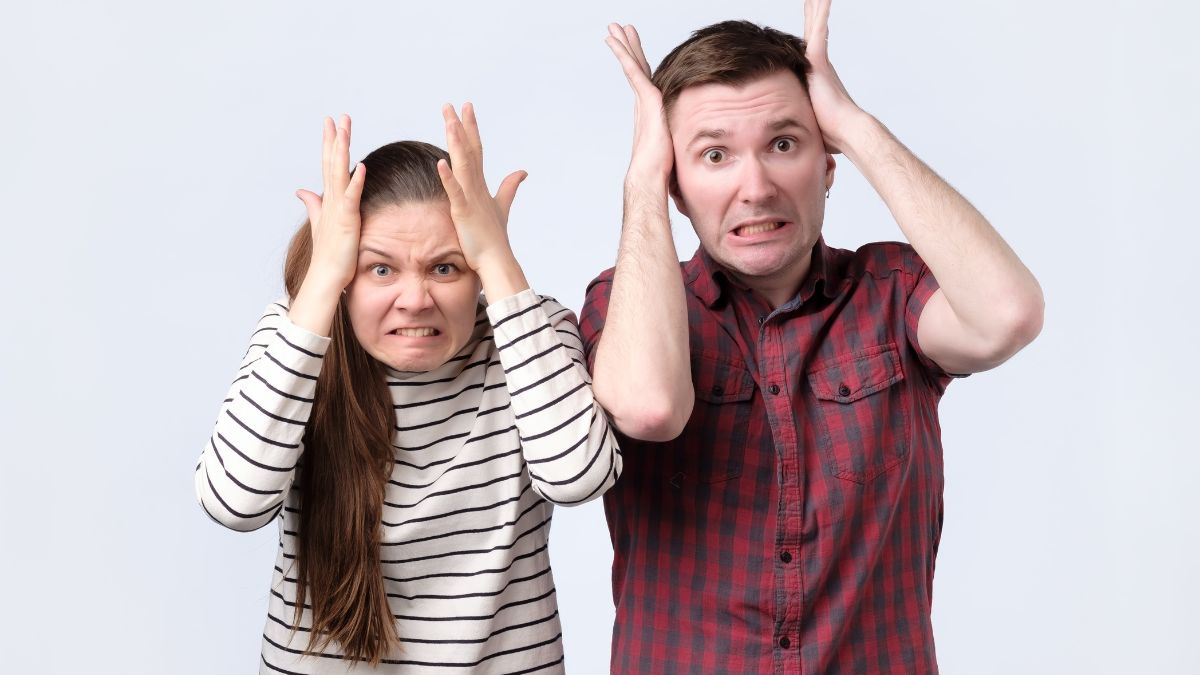 Couple standing together looking frustrated