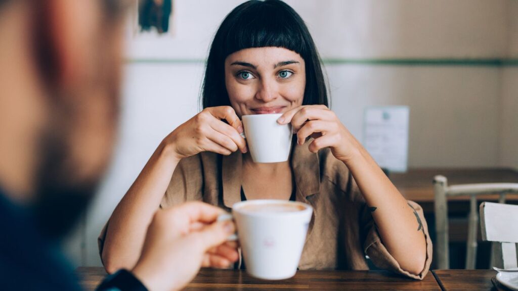 couples on at a table with coffee woman smiling