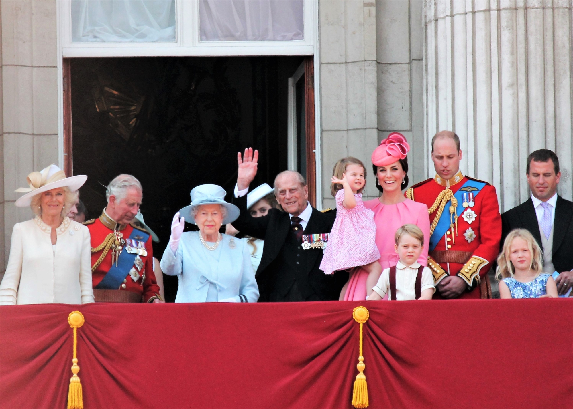 the royal family waving from a balcony