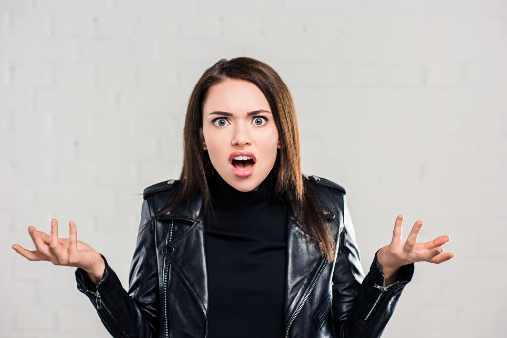 woman looking confused wearing a black leather jacket