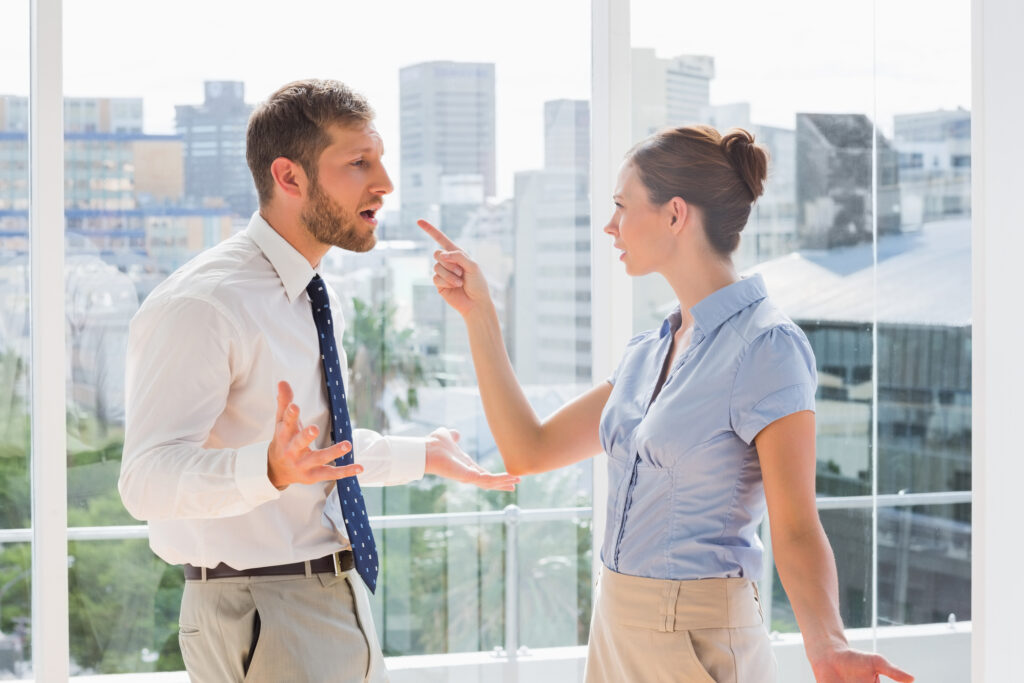 Couple having a heated argument in a bright office