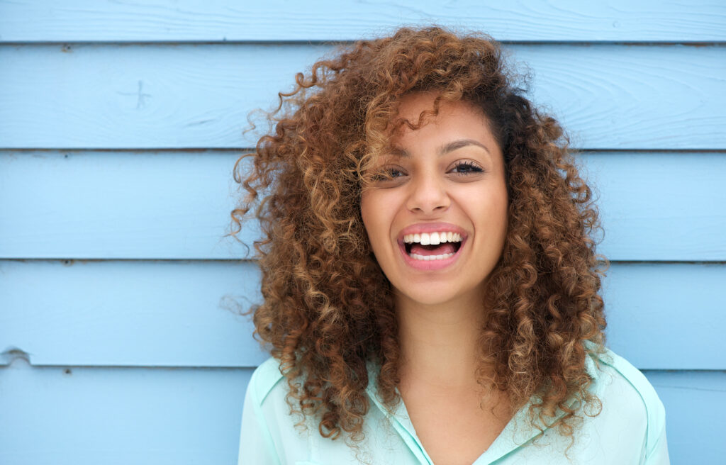 Portrait of a cheerful young african woman smiling