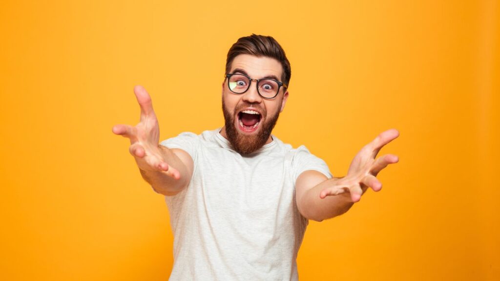 Excited man with glasses reaching his arms to you