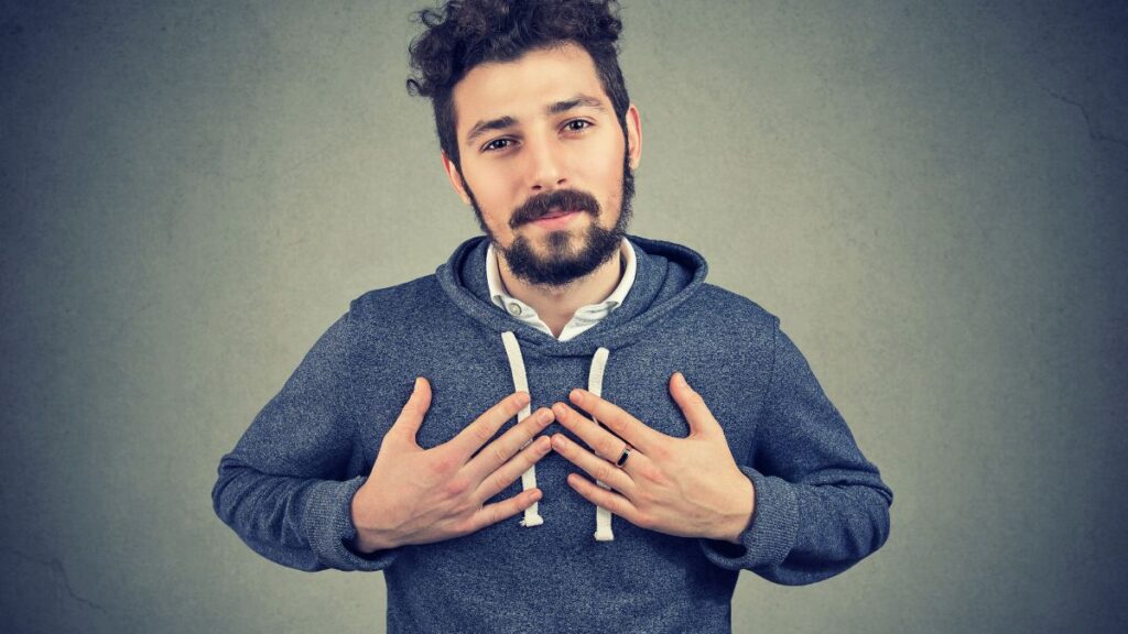 Forgiveness man with his hands on his chest showing compassion