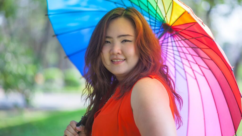 girl smiling with rainbow umbrella