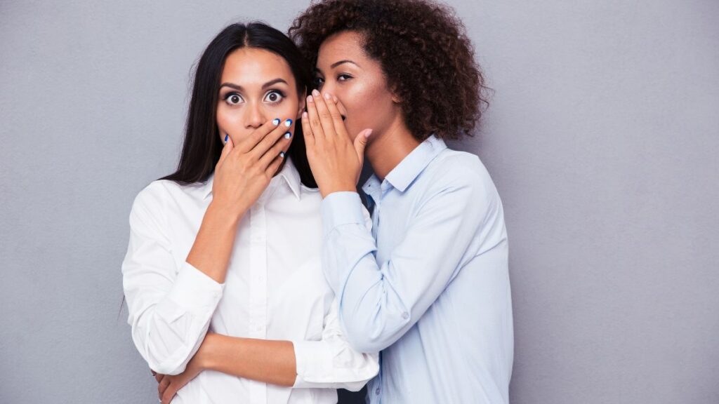 Gossiper one women whispering one woman looking surprised