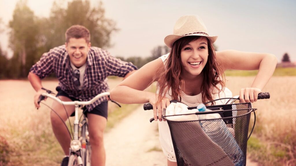 happy couple bike riding to a picnic