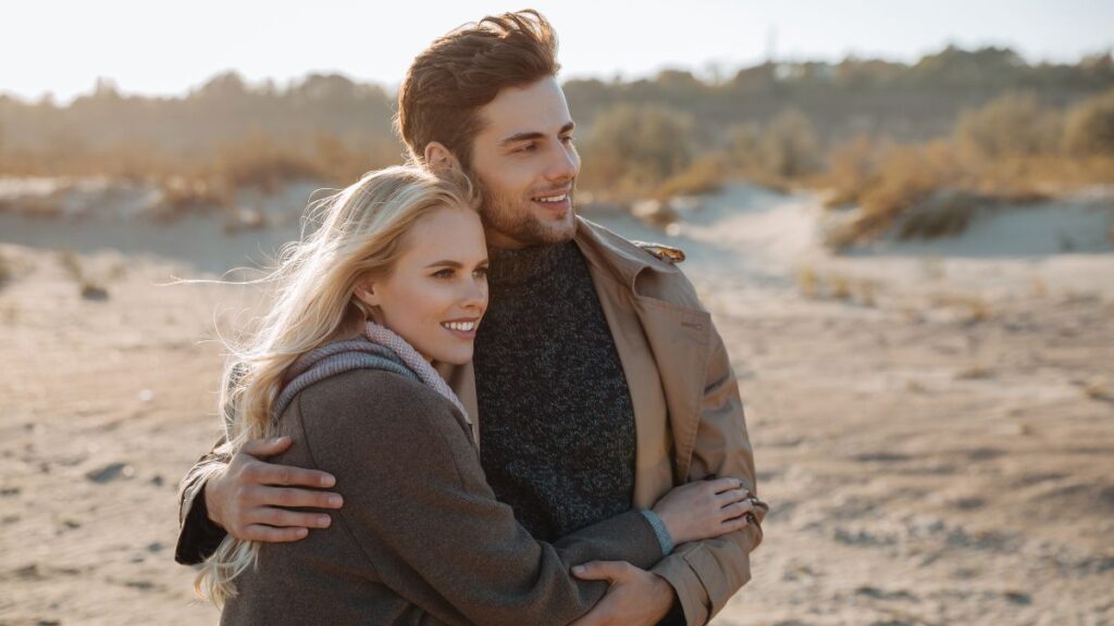 happy couple hugging on the beach