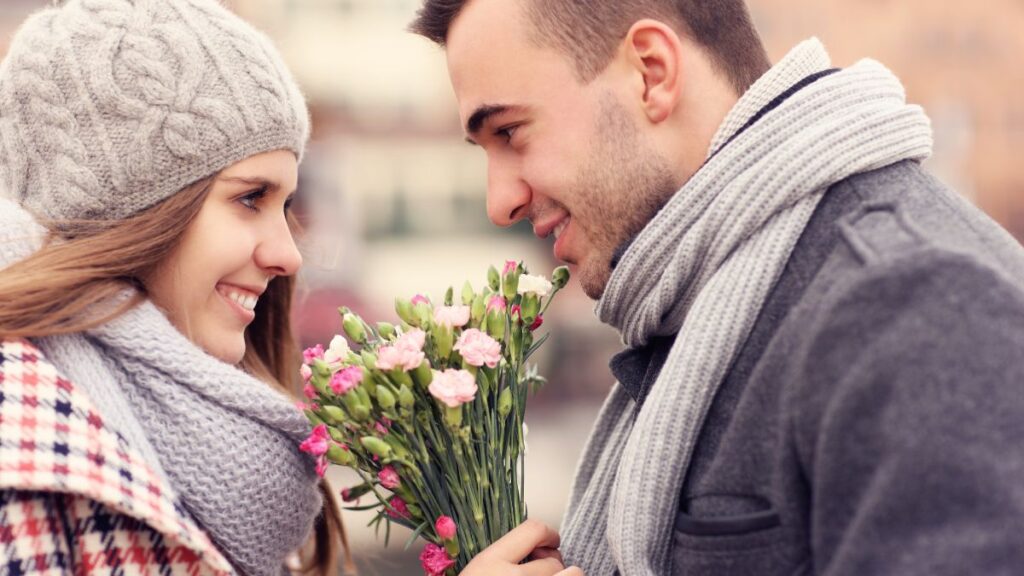 happy couple with flowers on a date