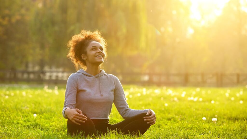 happy woman sitting in a field