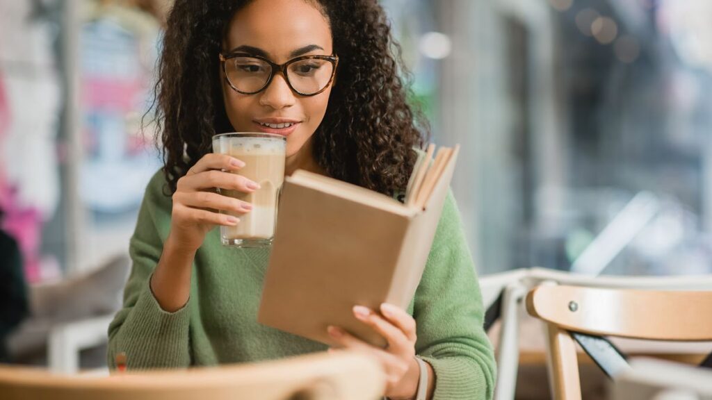 Hobbies woman reading a book with a cup of coffee