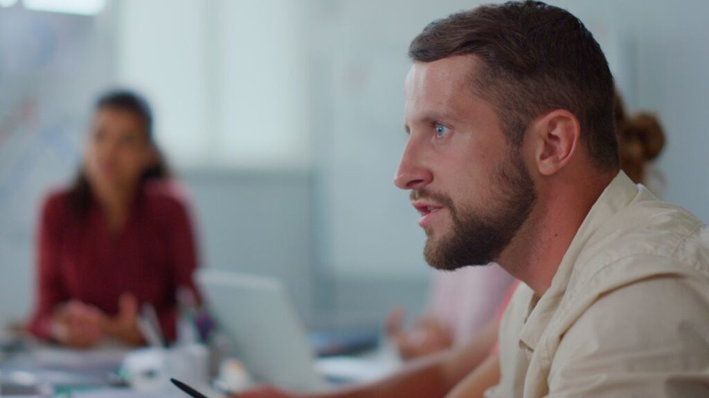 Insensitive Response: man sitting and making an intense face.