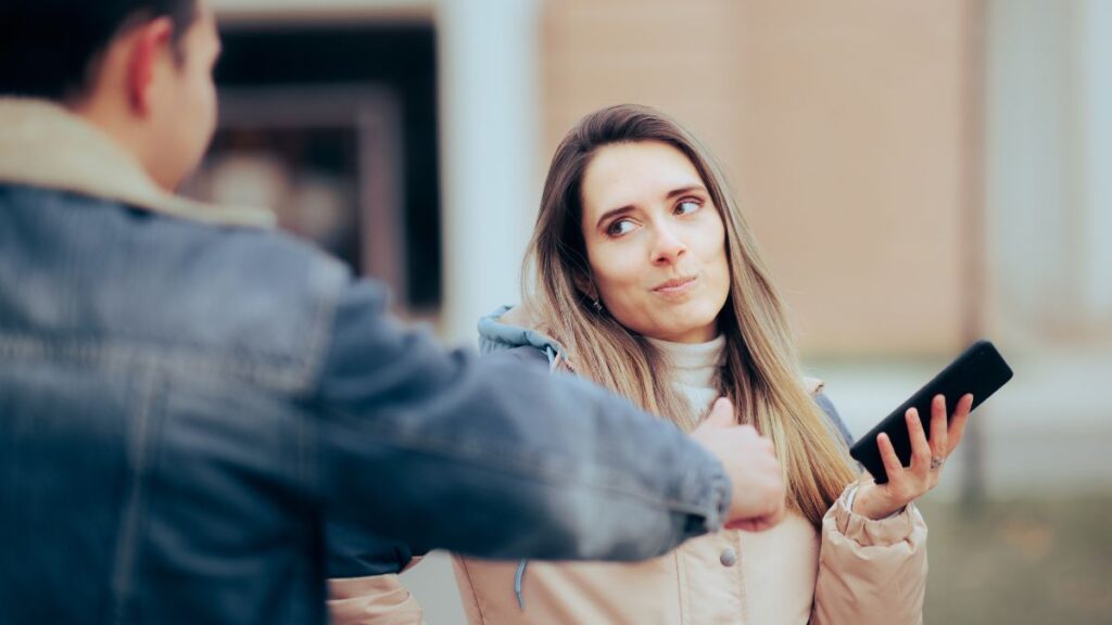 Invading Her Privacy: woman standing outside showing a man to back away from her.