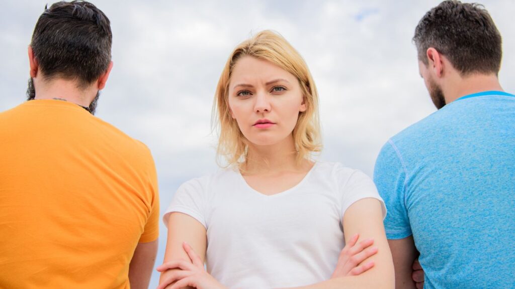 It's Her or Me Ultimatum: woman standing with a man on each side facing away from her