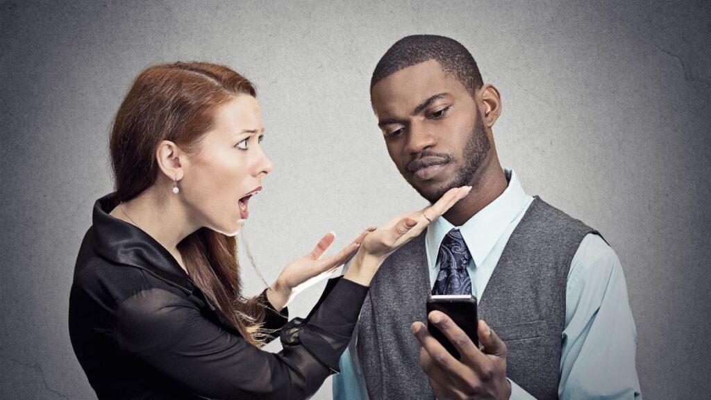 Man ignoring woman while on the phone