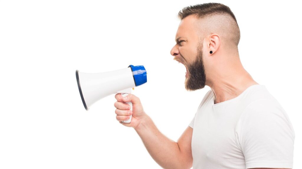 Loud man yells into a megaphone.