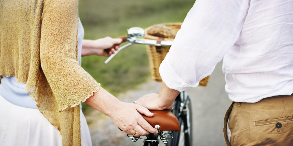 man and woman holding hands over a bike