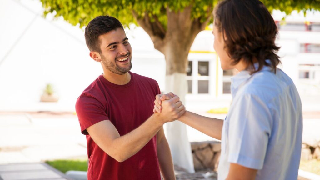 Male Greeting two men shaking hands