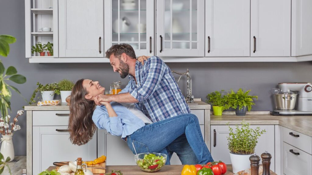 man and woman dancing in the kitchen