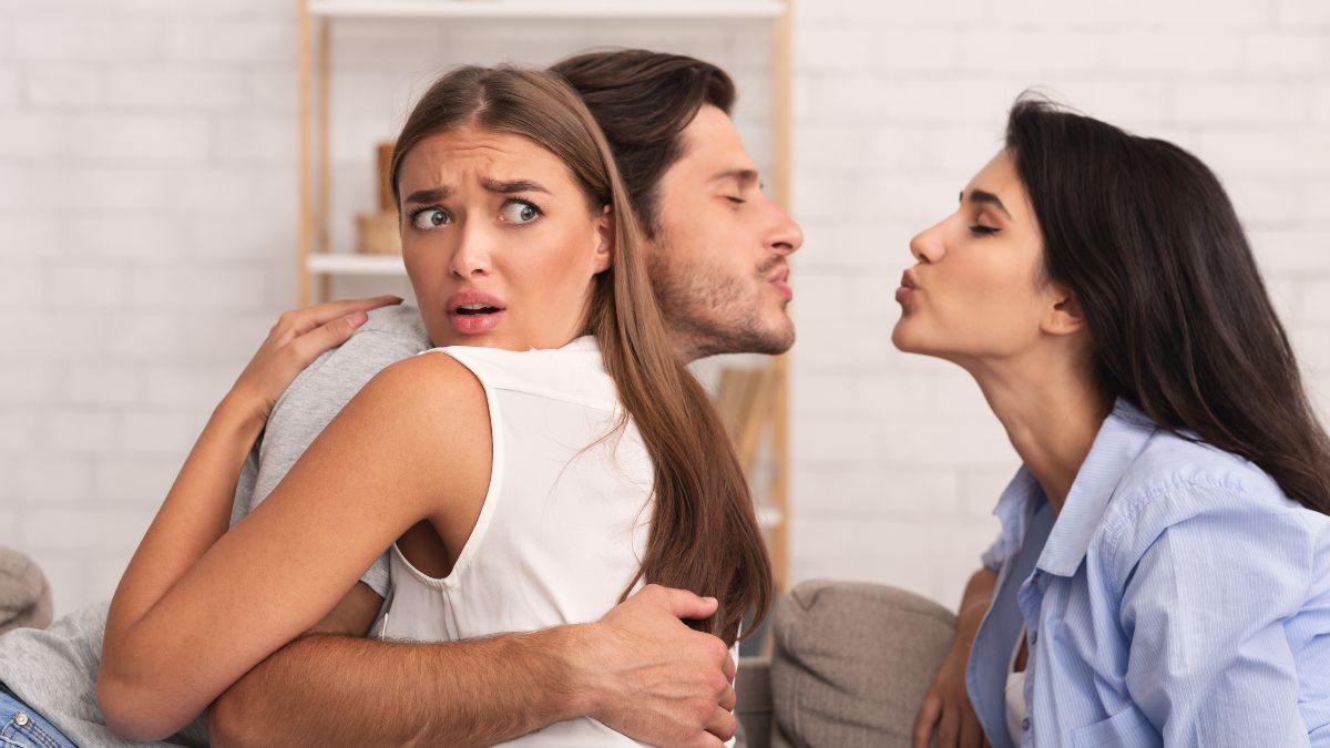 man and woman hugging while the man is kissing another woman