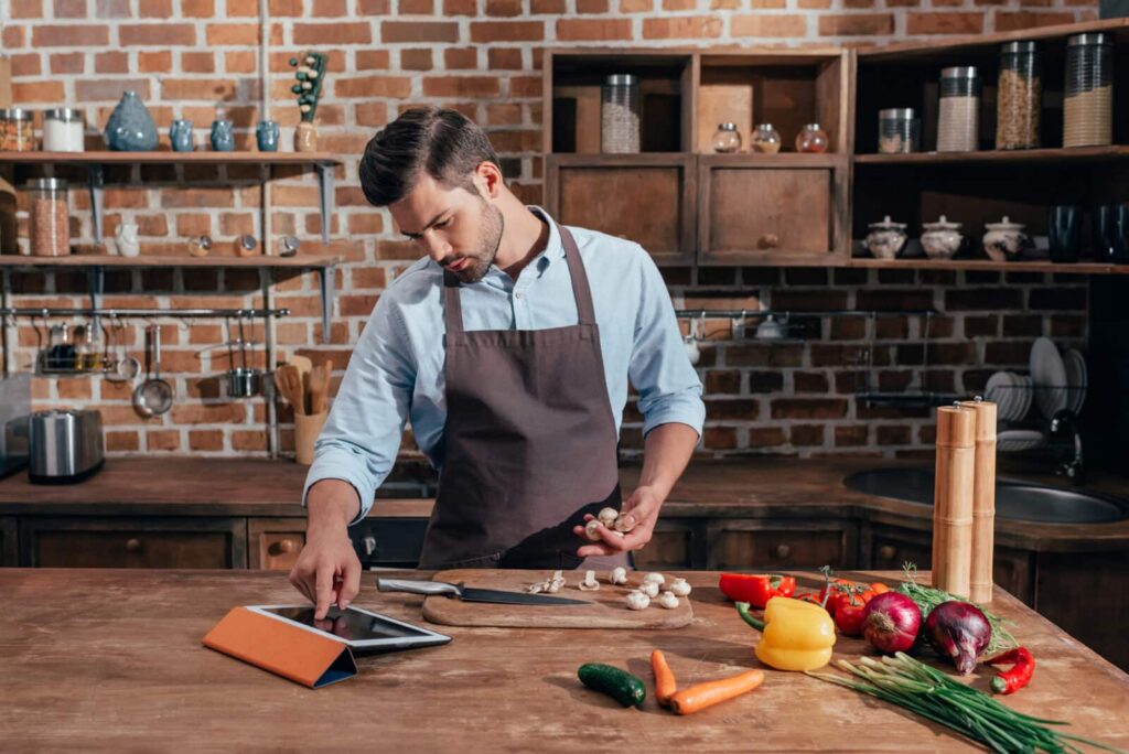 Man cooking over a wooden table.