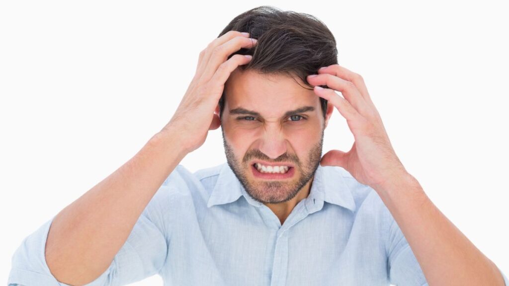 man looking frustrated with hands on his head