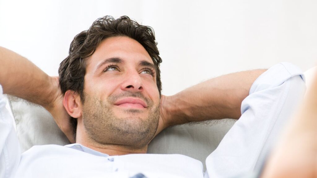 man relaxing smiling and looking up