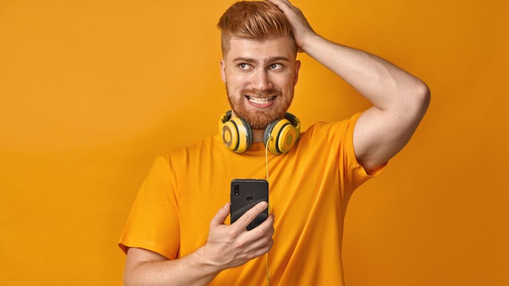 man standing with his hand on his head looking annoying