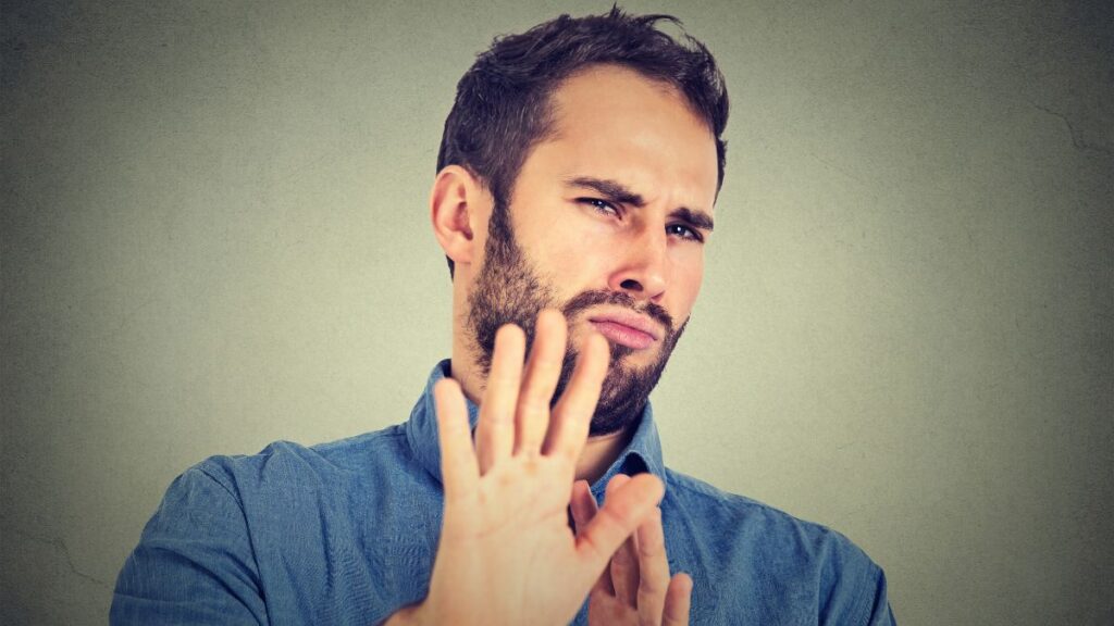 man with hands up showing stop