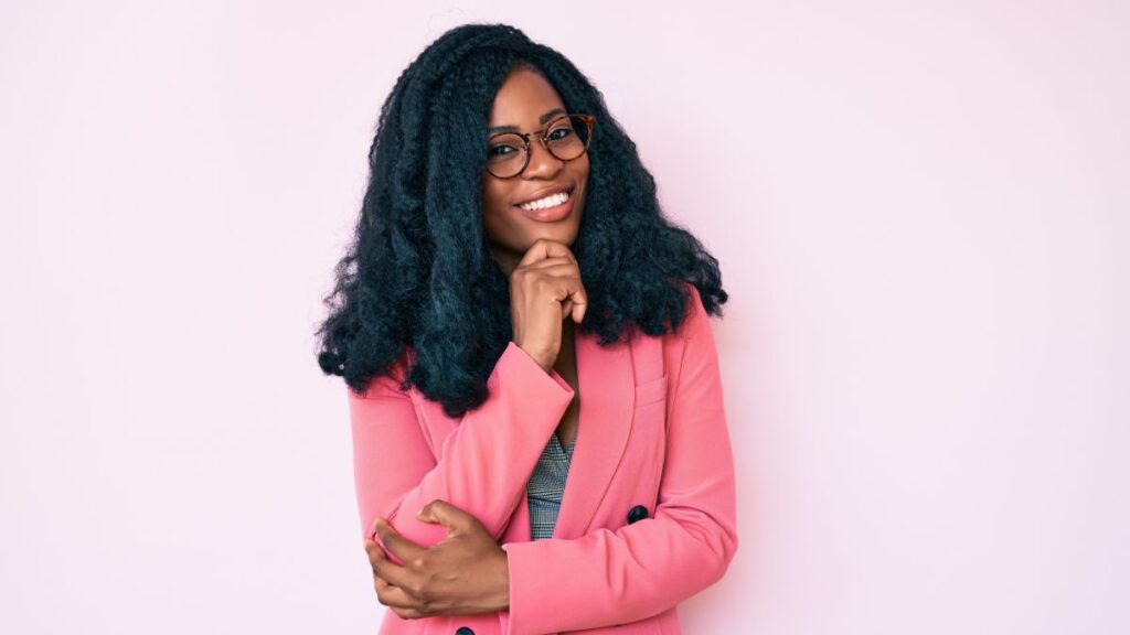 Maturing? Woman smiling confidently with her hand on her chin