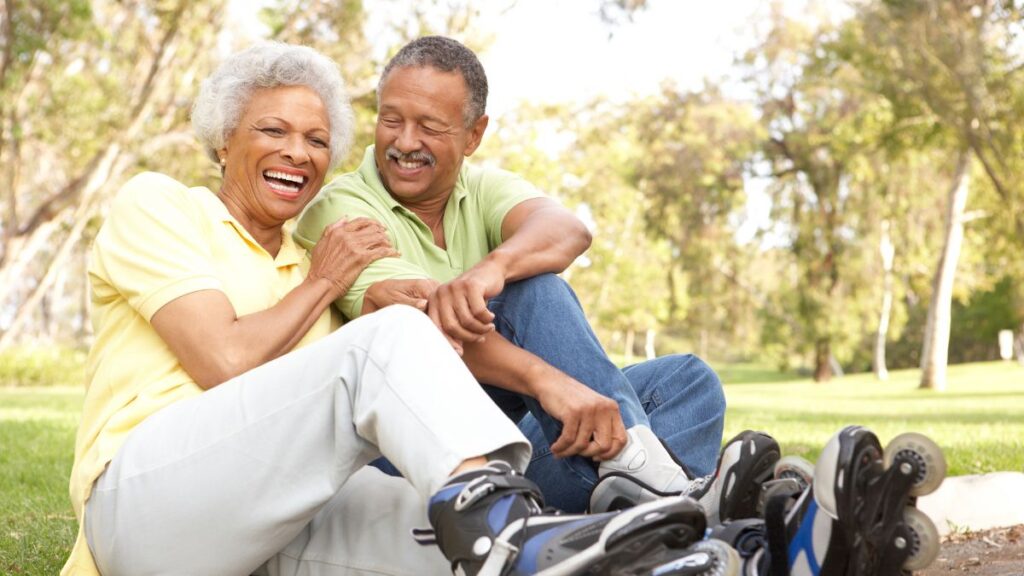 older couple sitting with rollerblades