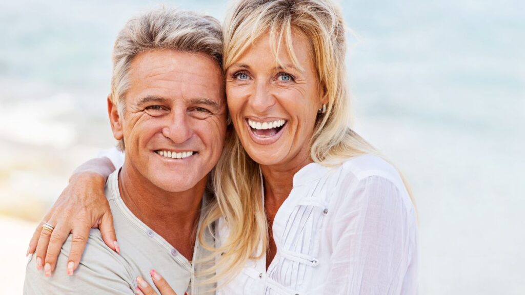 older couple smiling on the beach