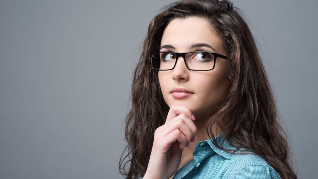 pensive woman with hand on her chin