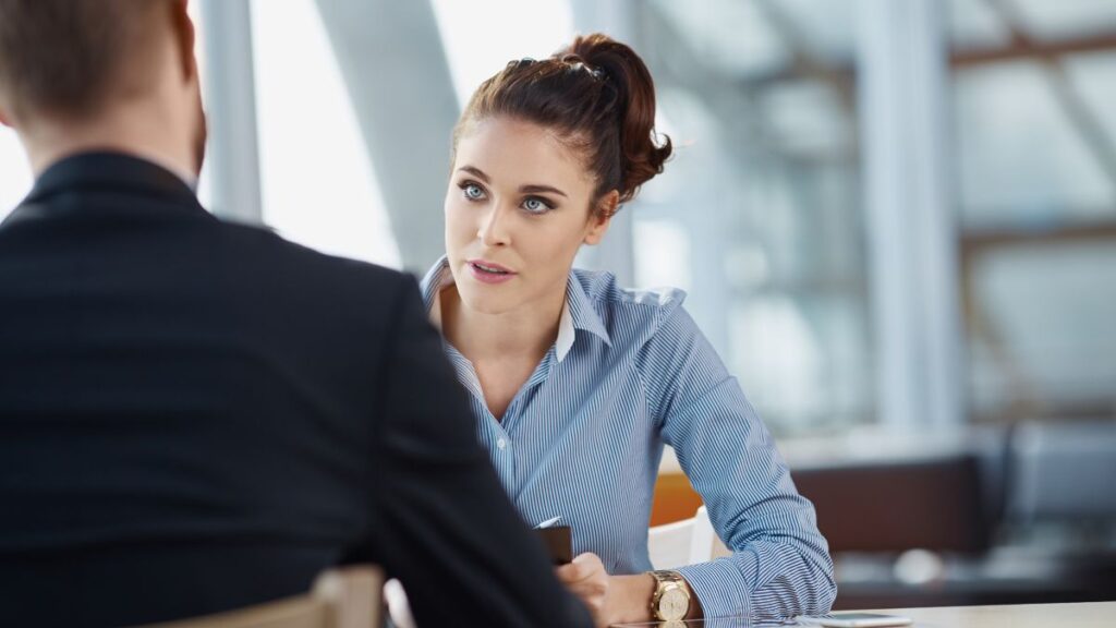 Personal Questions a woman sitting at a table talking to a man